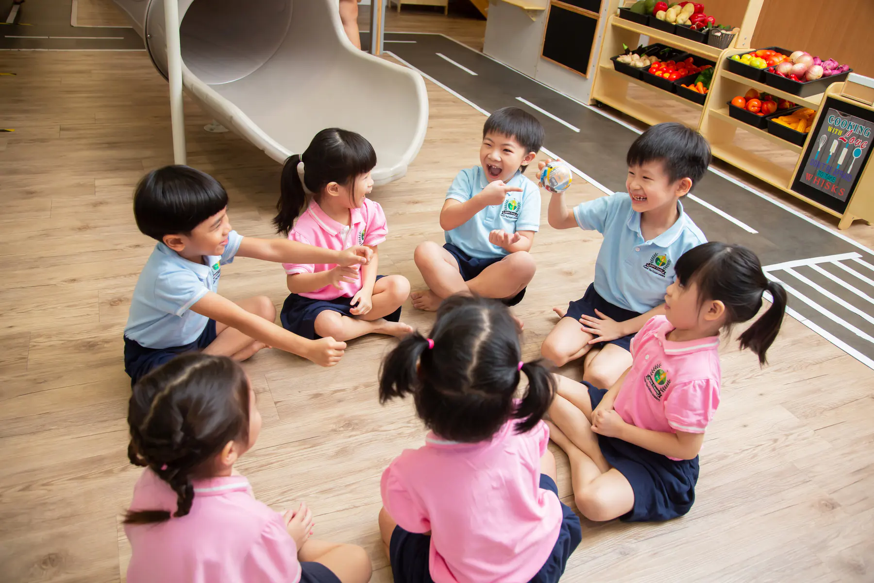 Alpha Castle children laughing and learning together in a classroom circle